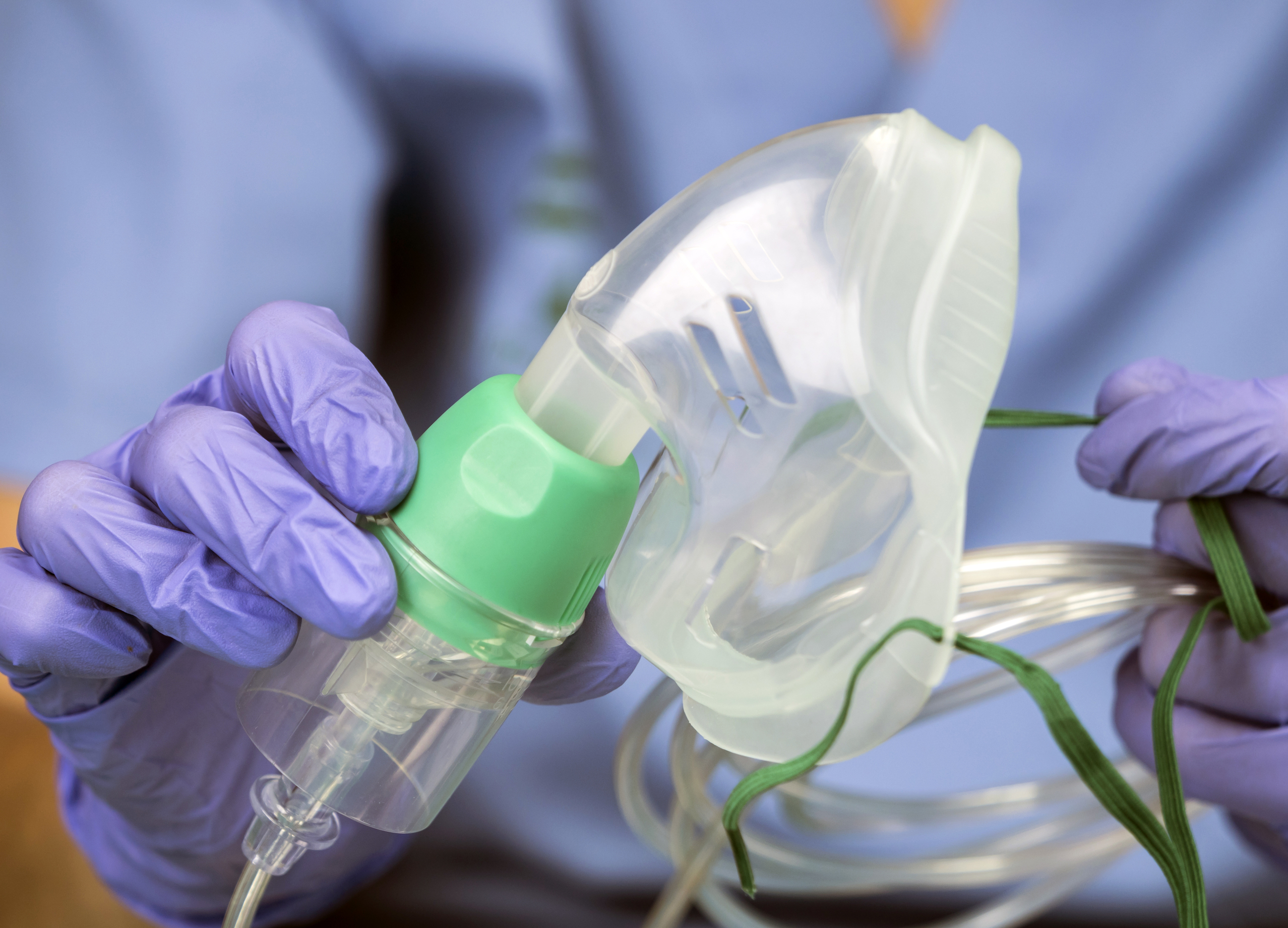 Nurse prepares oxygen mask in a hospital, conceptual image