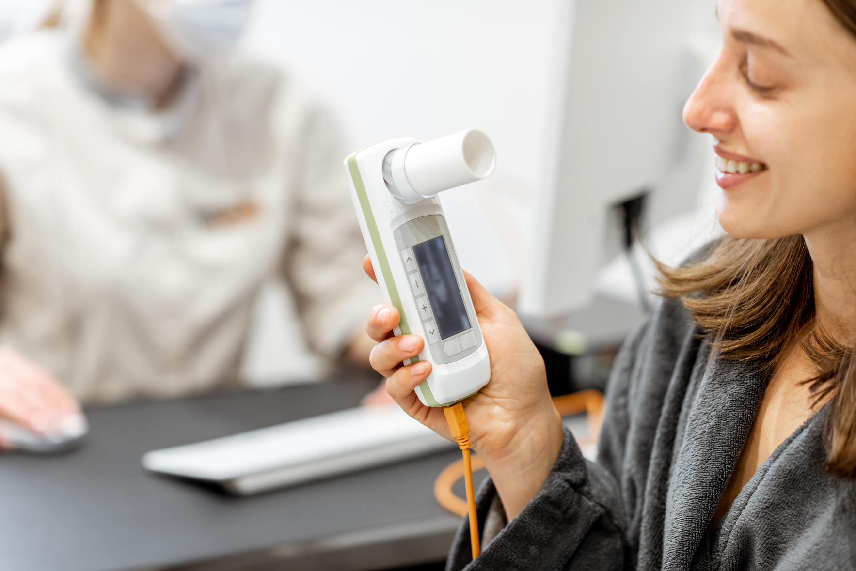 Young woman during a spirography test, measuring breathing movements with spirometer at medical Spa salon